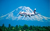 Plane flying past Mount Ranier